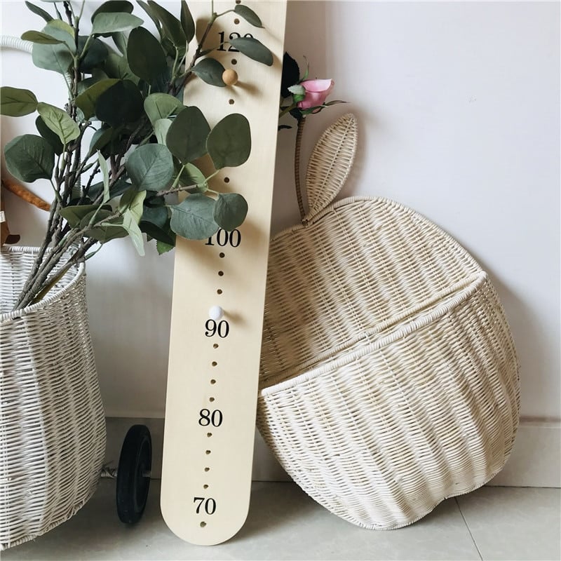 Apple shaped rattan wall baskets in brown and white with plush toys