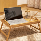 Bamboo bed tray with legs and handles set on a floor rug