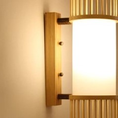 Slim cylinder wall sconce with bamboo slats and a white diffuser