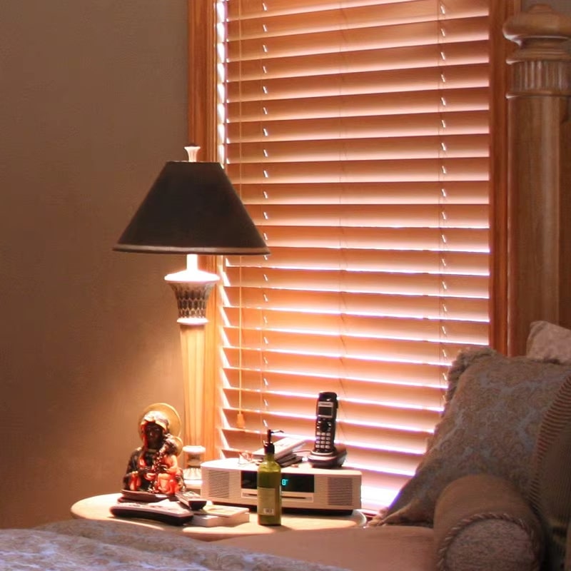 Warm brown bamboo venetian blinds with tilting slats in a living room