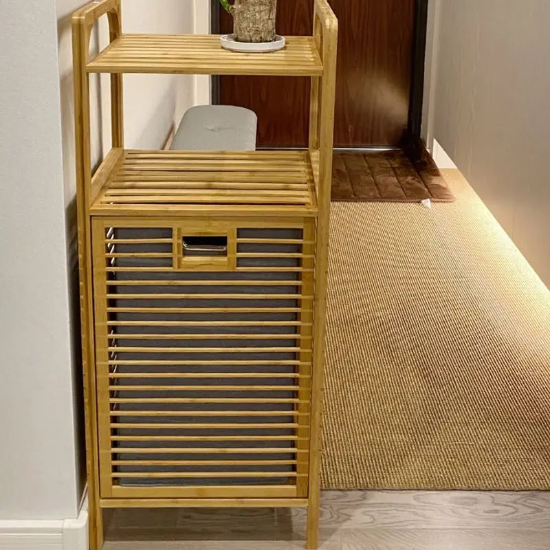 Tall bamboo storage cabinet with shelves and a slatted laundry compartment