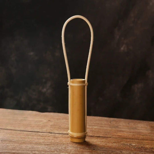 Bamboo tube vase with a tall bamboo loop handle