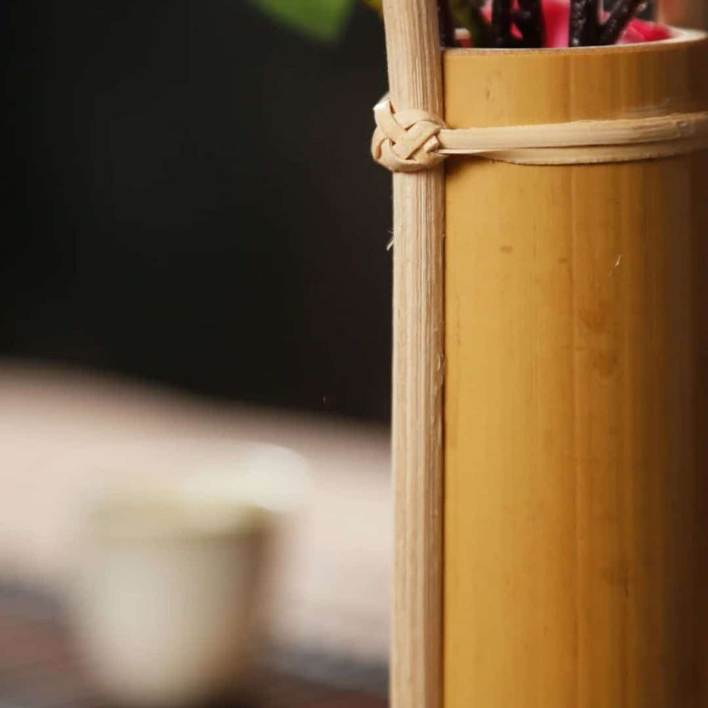 Bamboo tube vase with a tall bamboo loop handle