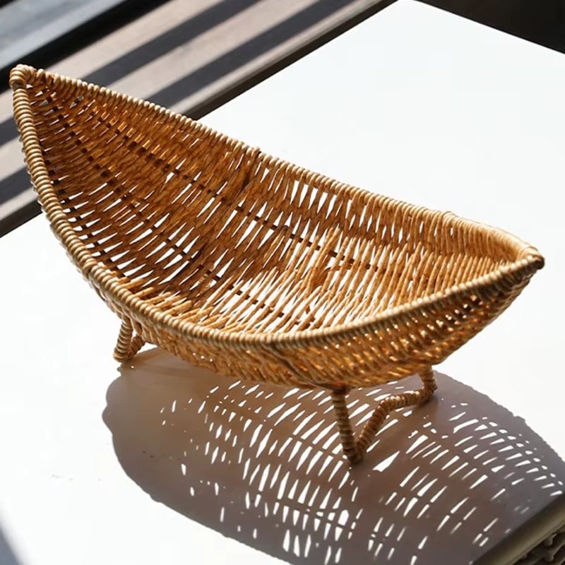Curved banana shaped rattan basket on small feet