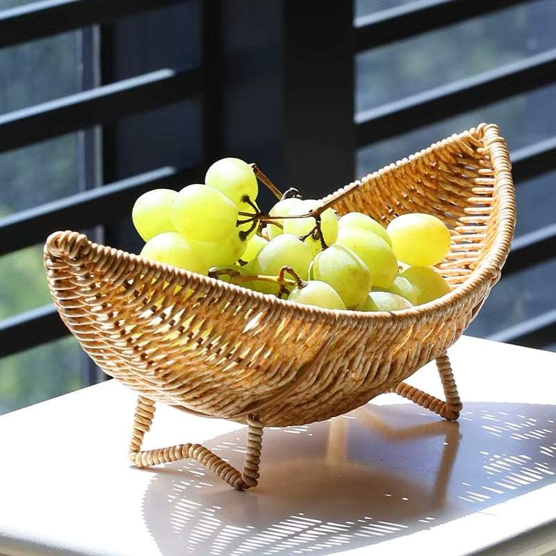 Curved banana shaped rattan basket on small feet