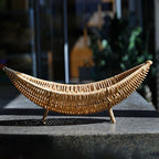 Curved banana shaped rattan basket on small feet