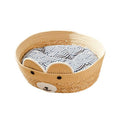 Round woven pet bed with a bear face and patterned cushion