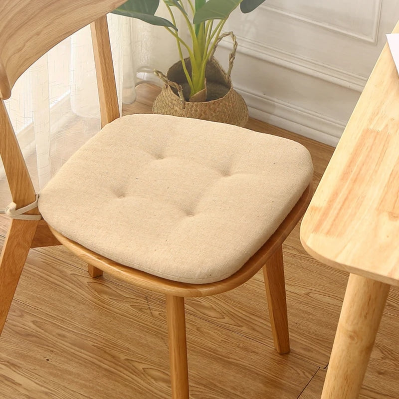 Beige thin polyester seat cushion with ties for a rattan chair