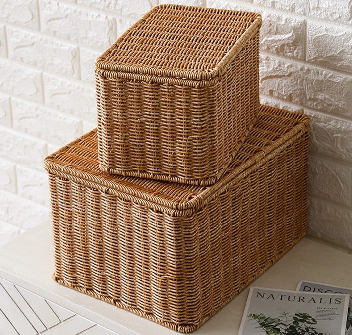 Stacked beige lidded woven storage boxes