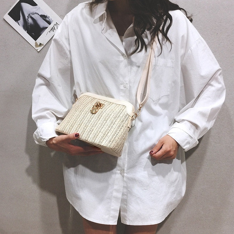 Rounded beige woven basket bag with a gold chain strap