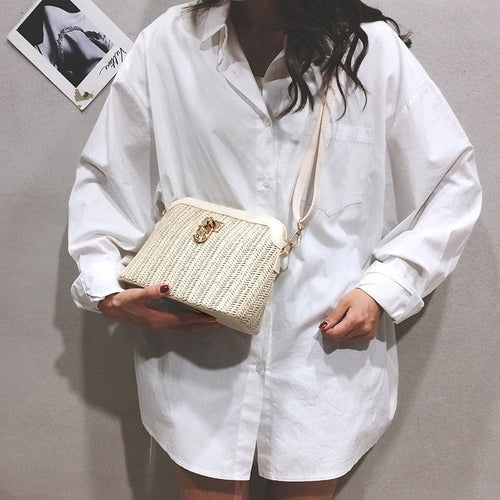 Rounded beige woven basket bag with a gold chain strap