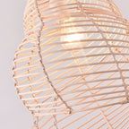 Beige open weave rattan pendant shaped like a conch seashell