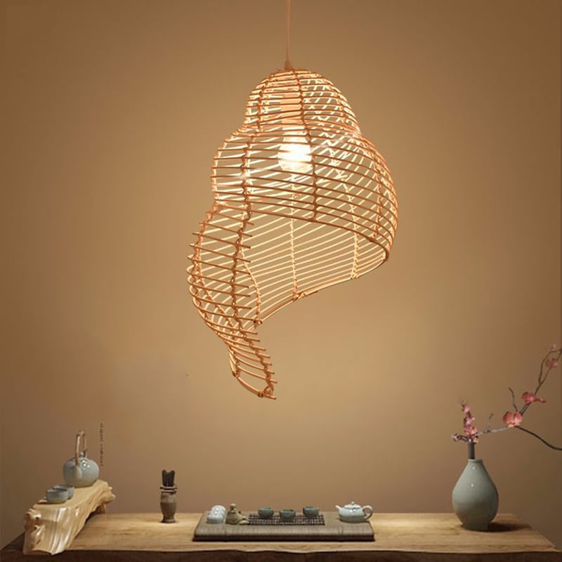 Beige open weave rattan pendant shaped like a conch seashell
