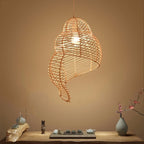 Beige open weave rattan pendant shaped like a conch seashell