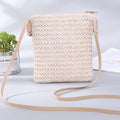 Compact beige woven straw and rattan crossbody bag with an adjustable strap