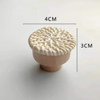 Round beige furniture knob with rattan woven around a wooden core