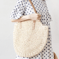 Roomy beige hand woven beach bag with sturdy handles