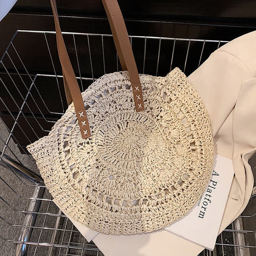 Roomy beige hand woven beach bag with sturdy handles