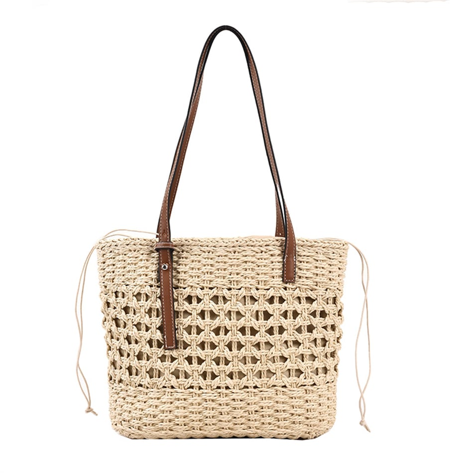 Rounded beige woven straw beach handbag with an adjustable strap