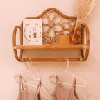 Rattan wall shelf shaped like a small bench with flower back