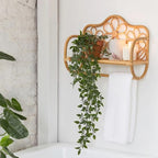 Rattan wall shelf shaped like a small bench with flower back