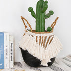 Black and natural belly basket with a fringe of white tassels