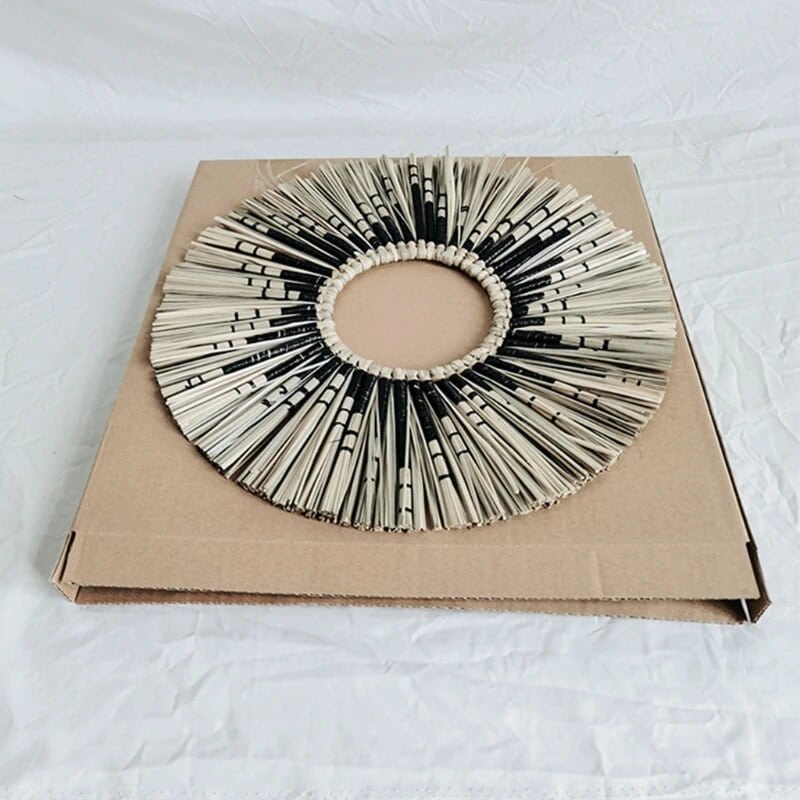 Round sunburst mirror with black and natural straw rays
