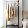 Tall black bamboo clothes rack with clean Asian inspired lines
