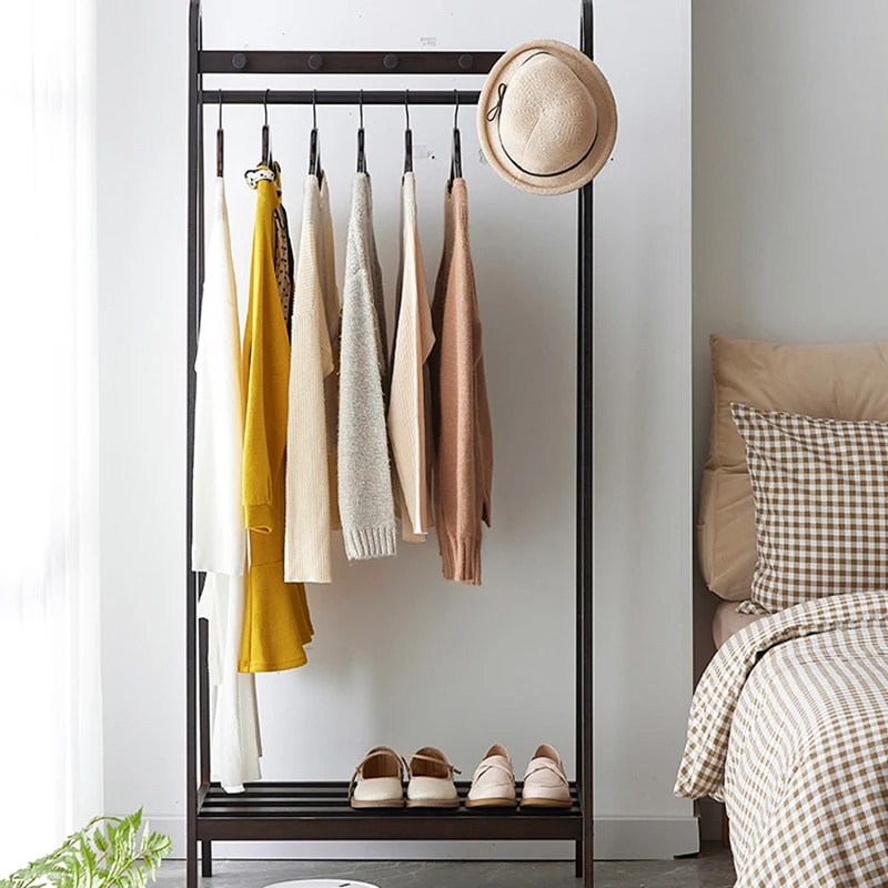 Tall black bamboo clothes rack with clean Asian inspired lines