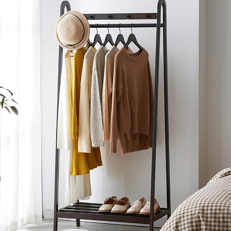 Tall black bamboo clothes rack with clean Asian inspired lines
