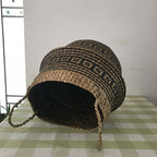 Woven belly basket with black geometric pattern and handles