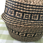 Woven belly basket with black geometric pattern and handles