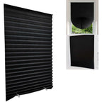 Black pleated shades clipped to two bedroom windows