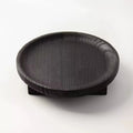 Round black wooden fruit bowl with visible wood grain