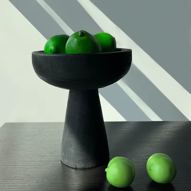Black wooden pedestal fruit bowl on a flared base