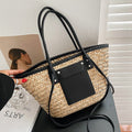 Structured black woven rattan beach bag with a handle and shoulder strap