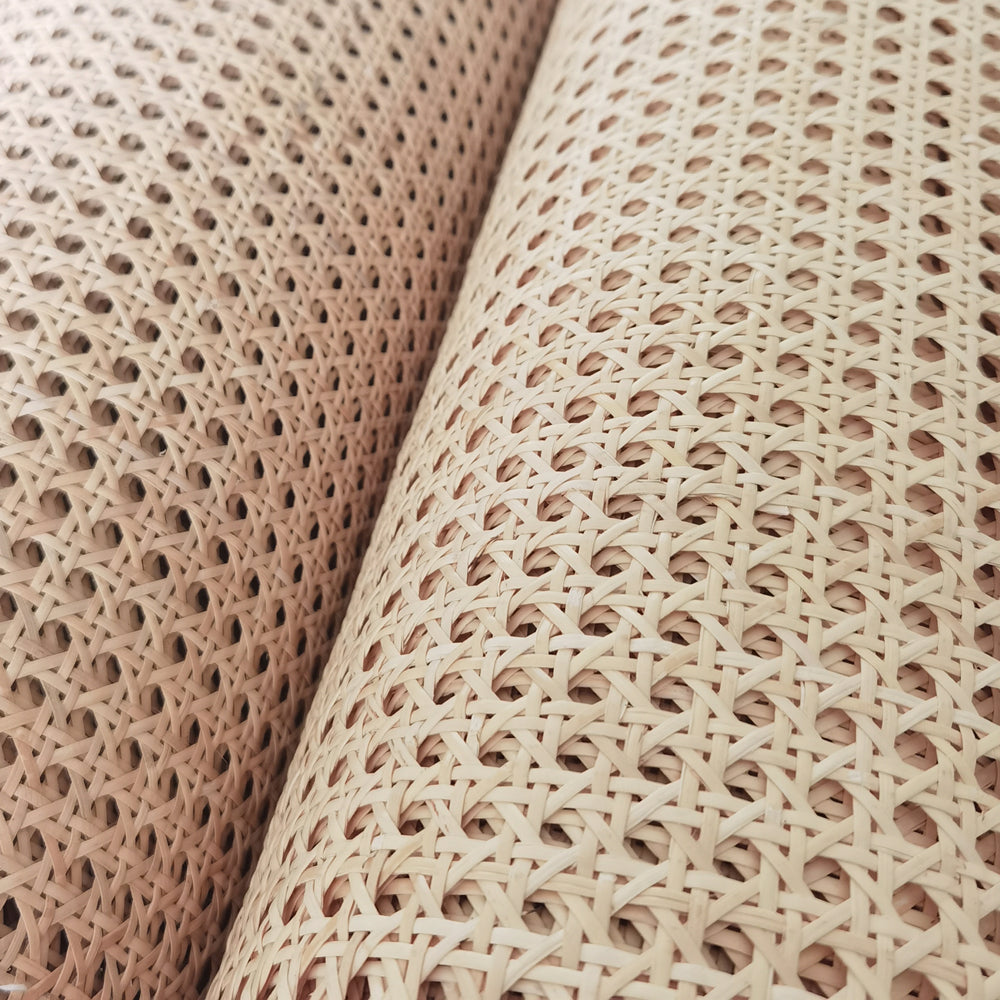 Roll of bleached rattan cane webbing with a round open mesh