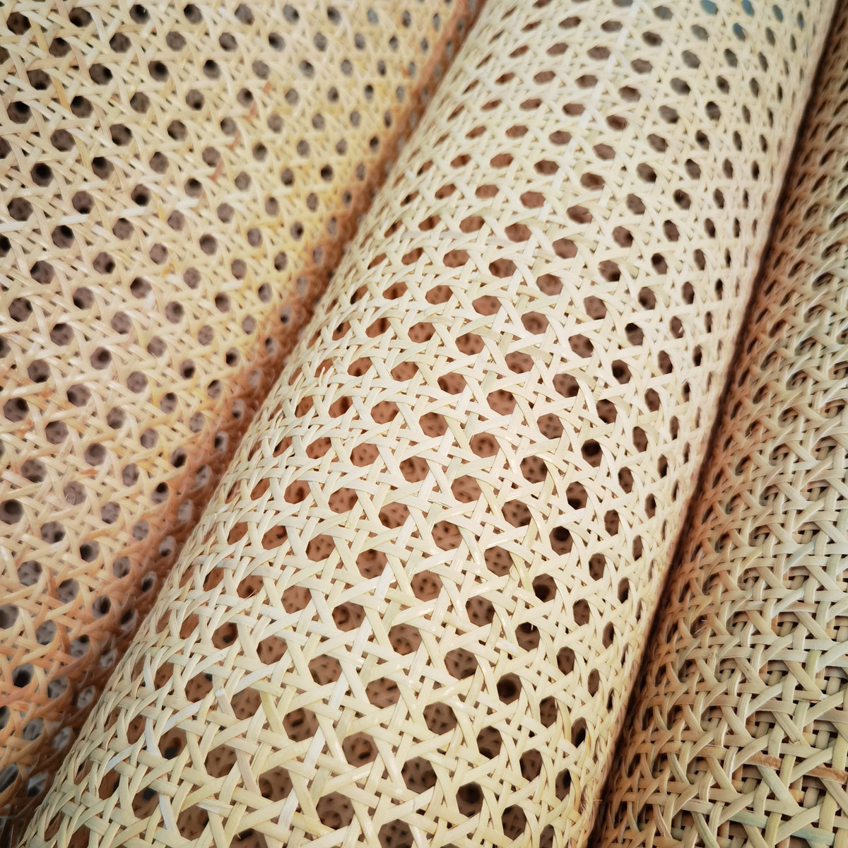 Roll of bleached rattan cane webbing with a round open mesh