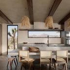 Row of three shaggy boho fringe pendants over a kitchen island