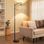Boho floor lamp with a hand woven rattan shade on a slim black stand