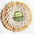 Round mirror framed by straw fringe and cotton macrame mandala