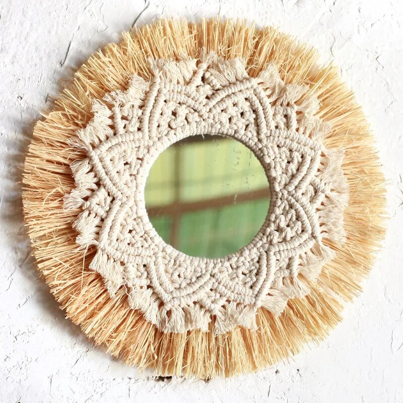 Round mirror framed by straw fringe and cotton macrame mandala