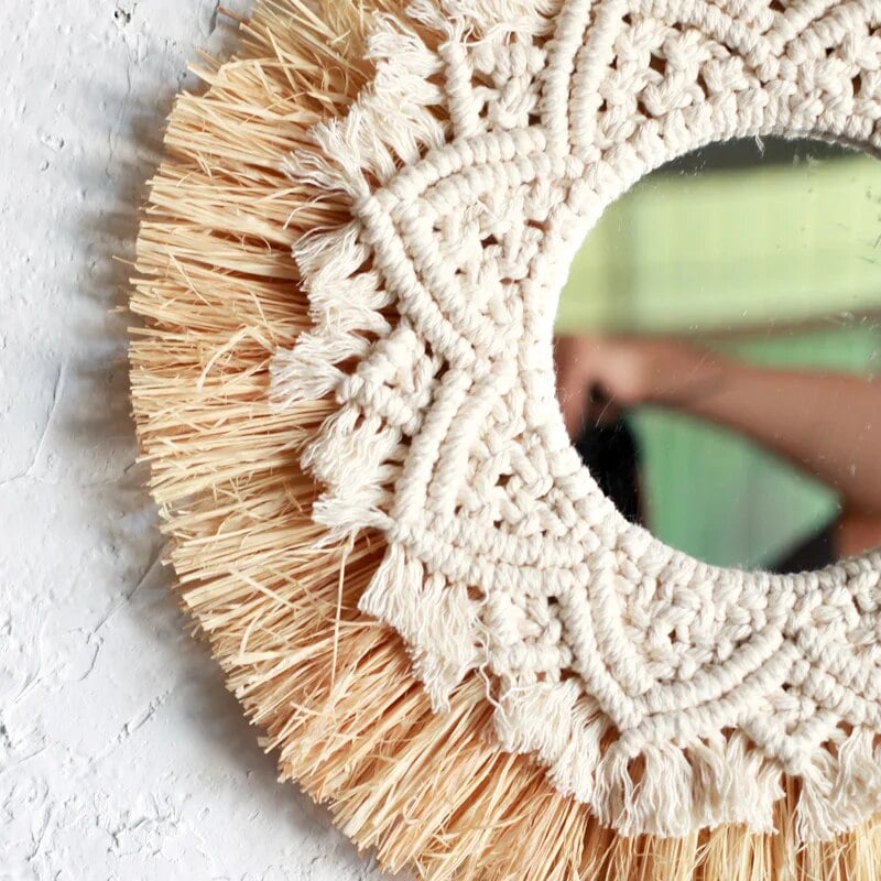 Round mirror framed by straw fringe and cotton macrame mandala