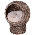 Round braided cat bed on a braided pedestal with a beige cushion