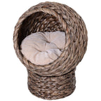 Round braided cat bed on a braided pedestal with a beige cushion