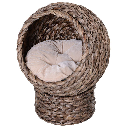 Round braided cat bed on a braided pedestal with a beige cushion