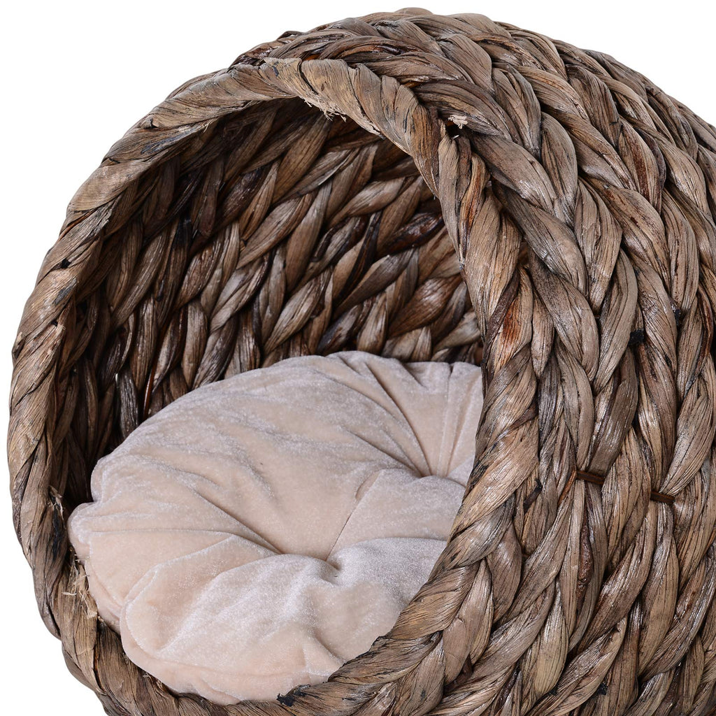 Round braided cat bed on a braided pedestal with a beige cushion