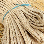 Bundle of flat braided natural rattan craft cord