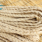 Bundle of flat braided natural rattan craft cord