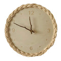 Round wall clock with a braided rattan rim and beige dial
